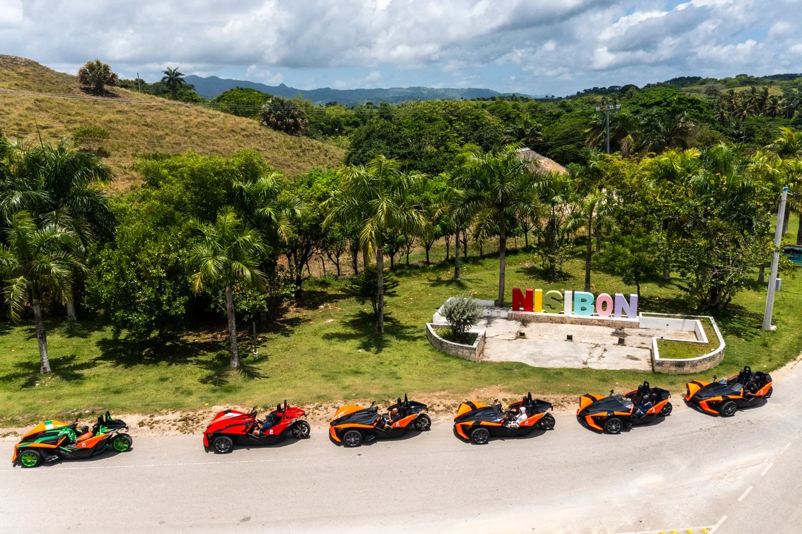Aerial view of the guided Punta Cana Slingshot convoy beside the colorful Nisibón sign