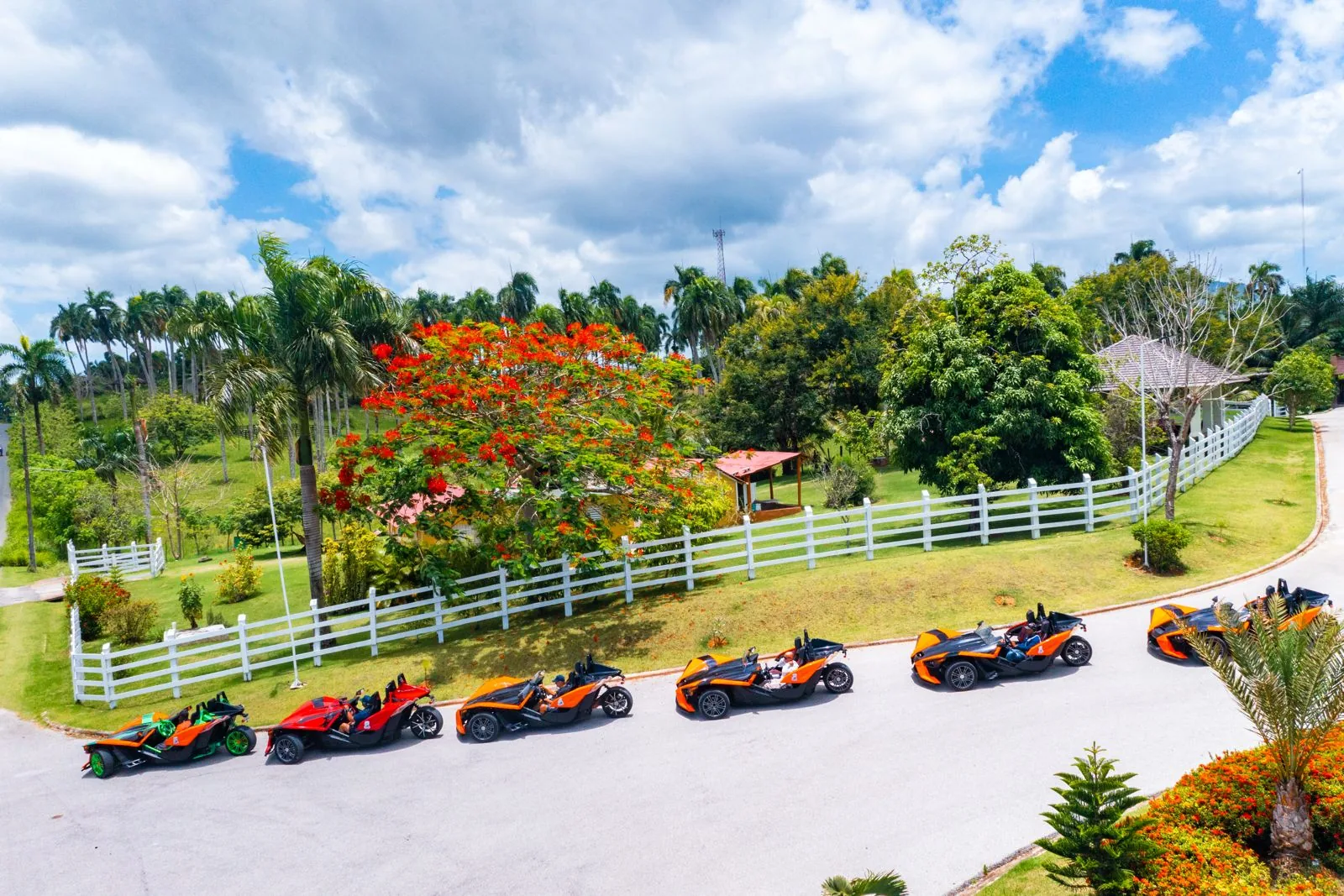 Aerial view of Polaris Slingshots driving through tropical countryside toward Macao Beach