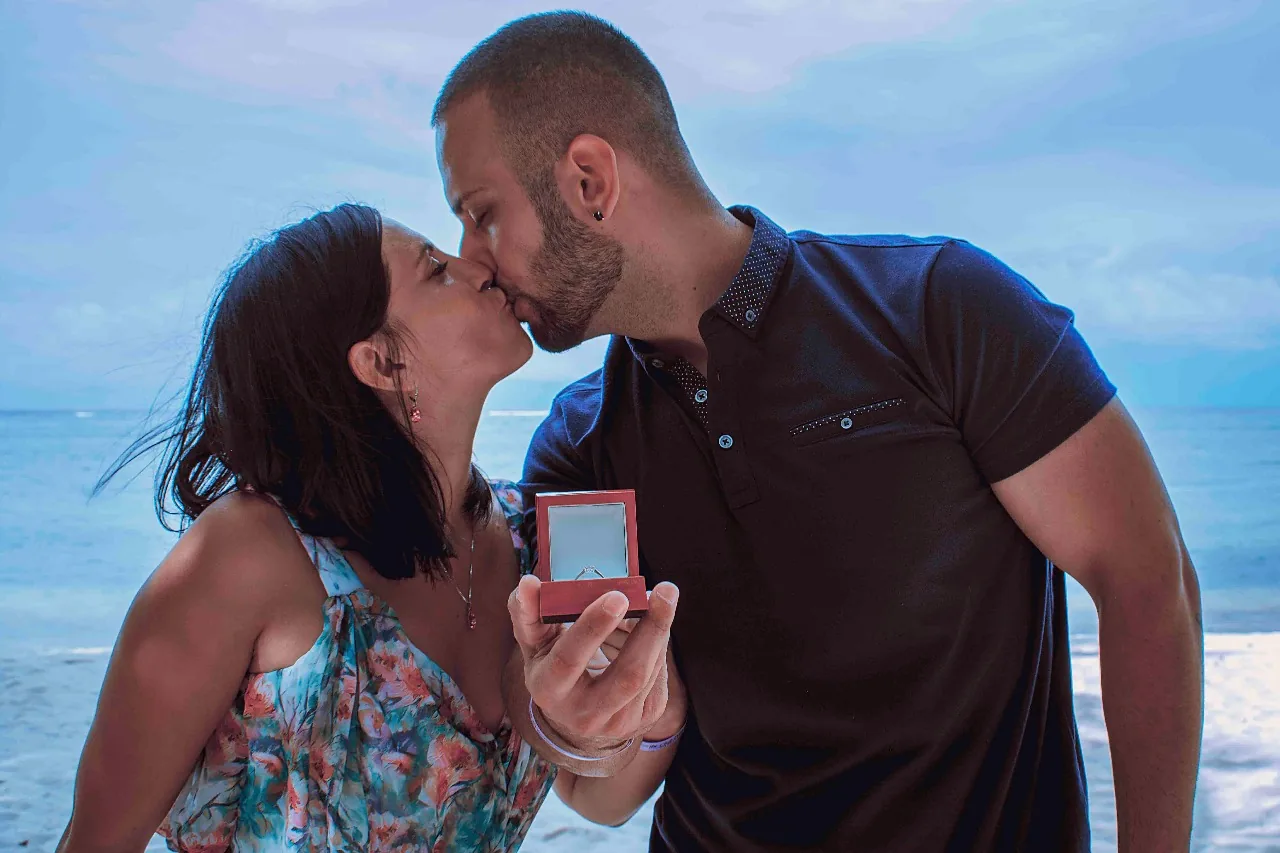 Newly engaged couple kissing with engagement ring on a Punta Cana beach