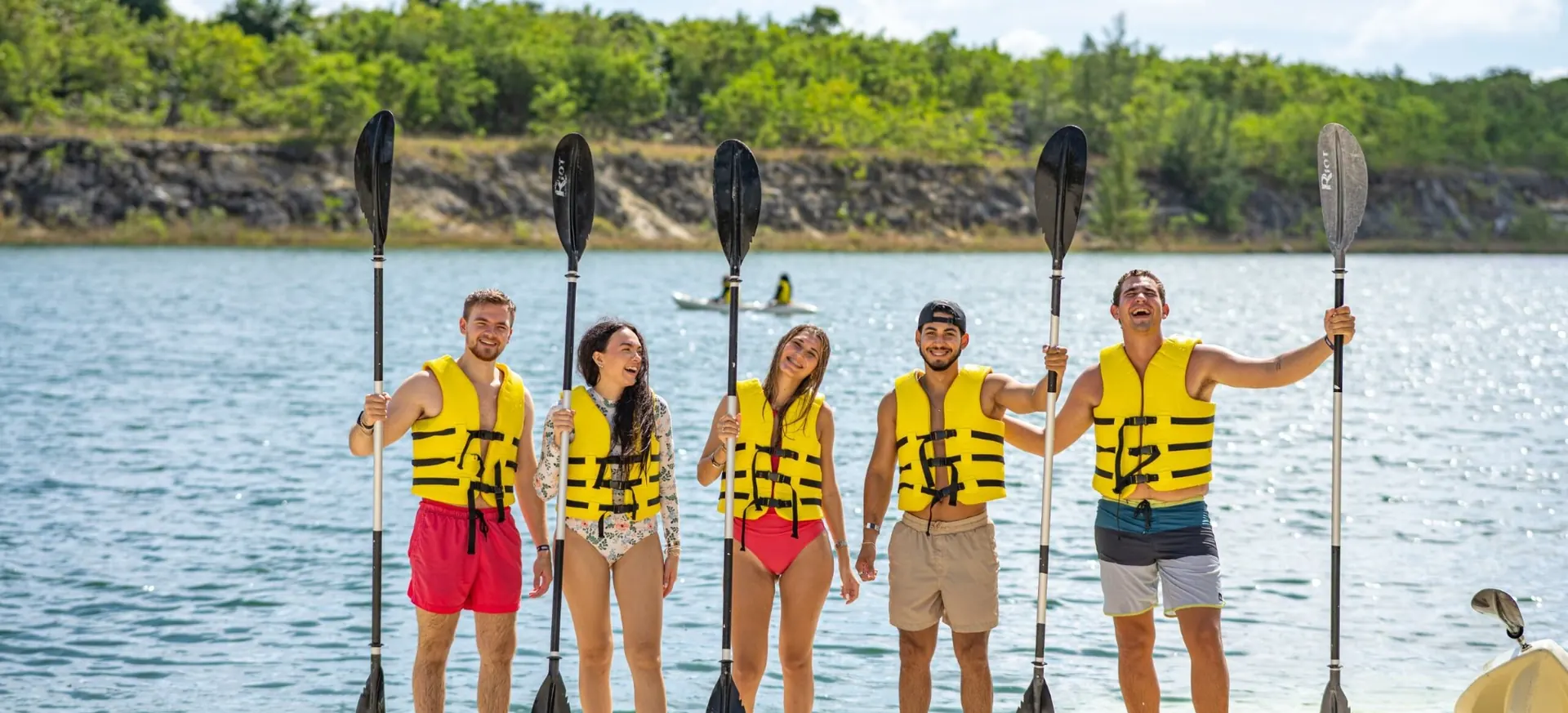 Group of friends with paddles ready for kayaking at El Dorado Park Punta Cana.