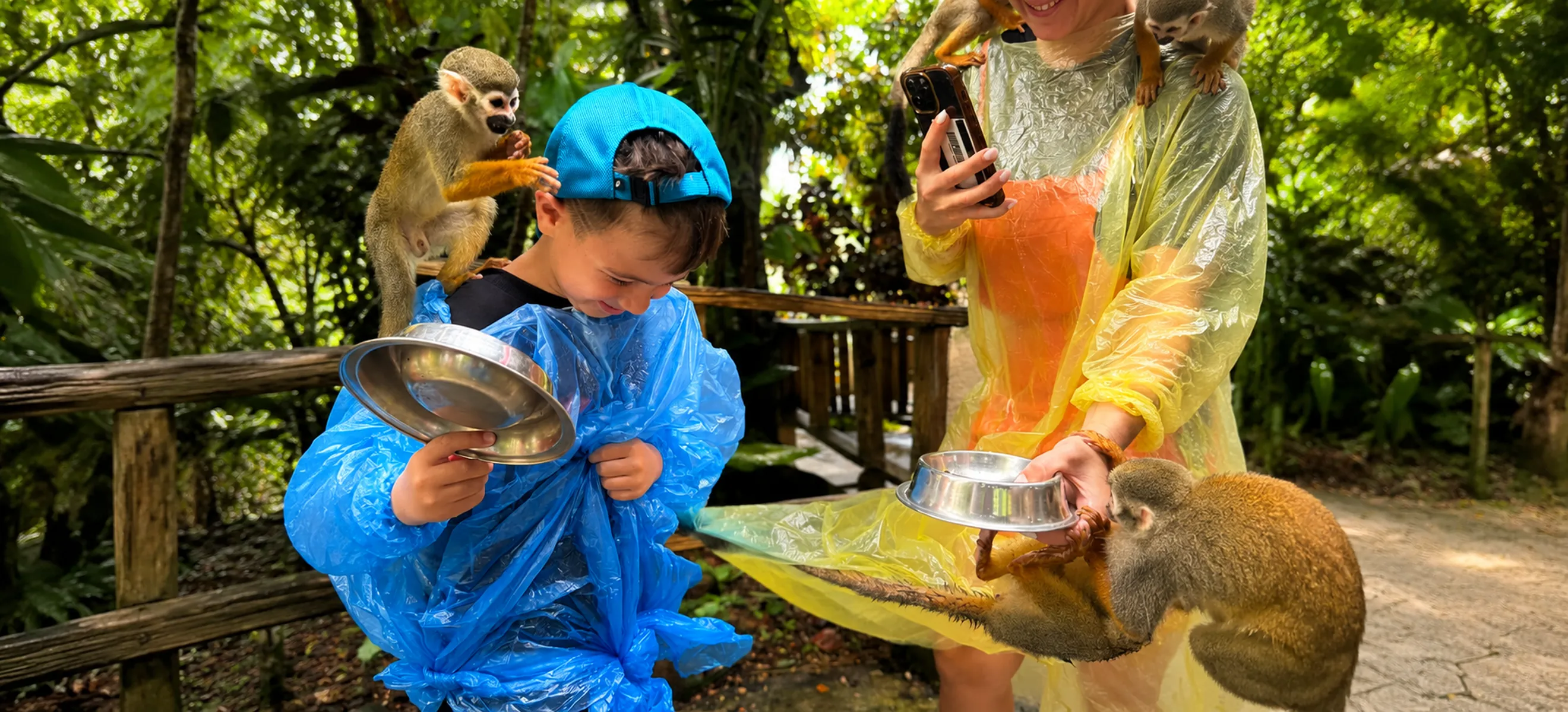 Family feeding squirrel monkeys at Monkeyland Punta Cana