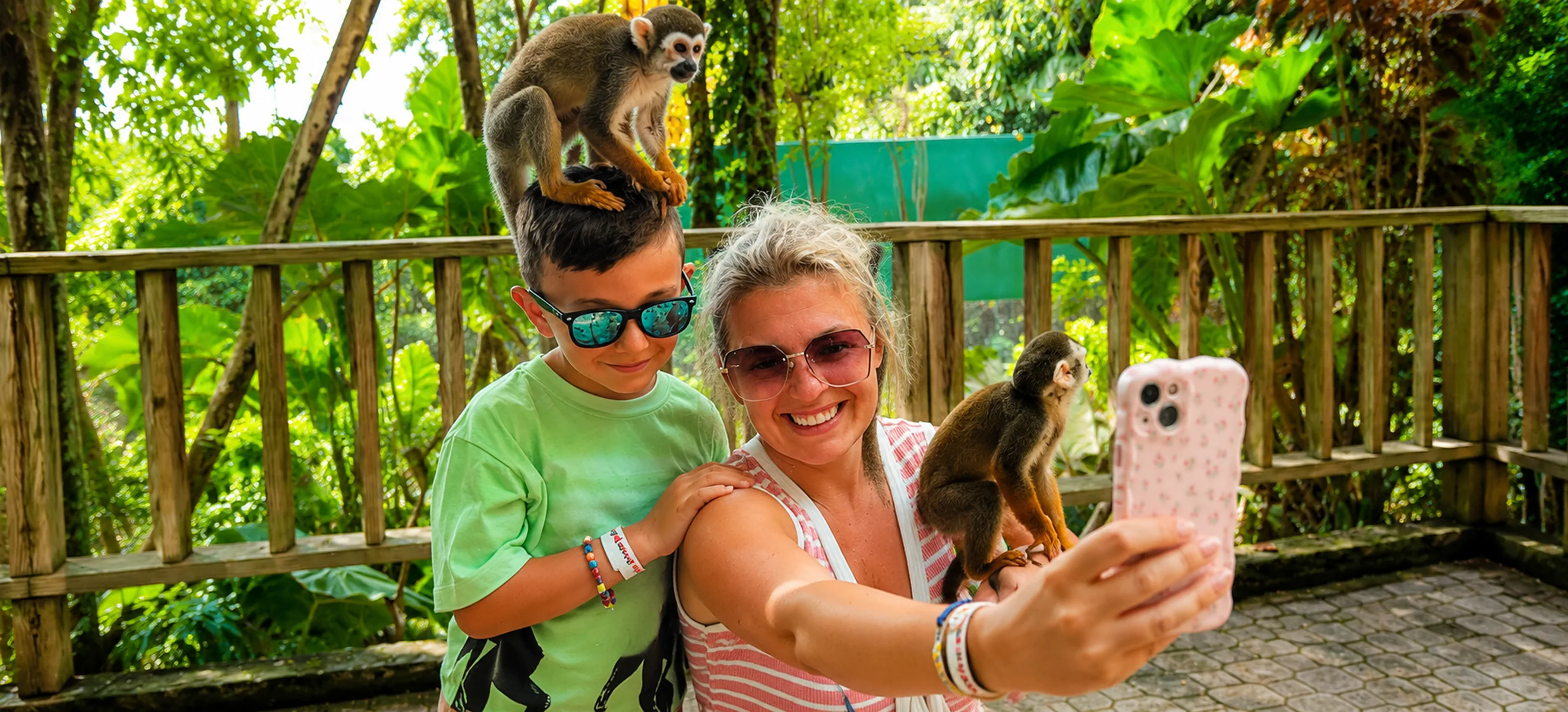 Child enjoying a close squirrel monkey encounter at Monkeyland Punta Cana