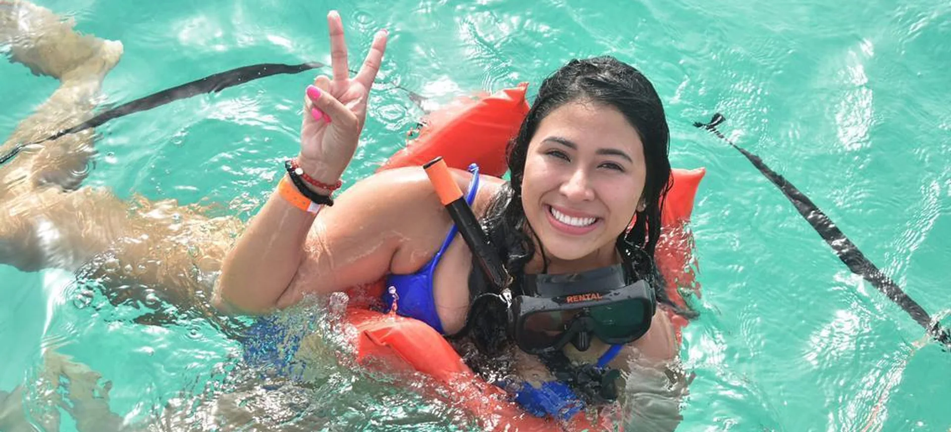 Smiling guest floating with snorkel gear during Vibra Party Boat tour in Punta Cana