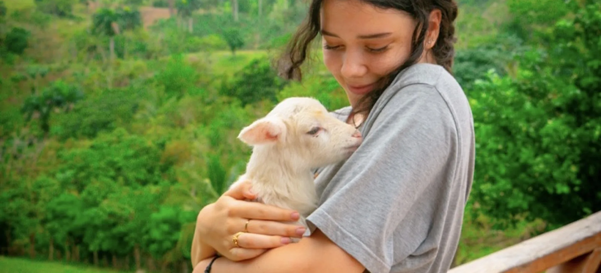 Guest holding a baby goat during a countryside tour in Punta Cana