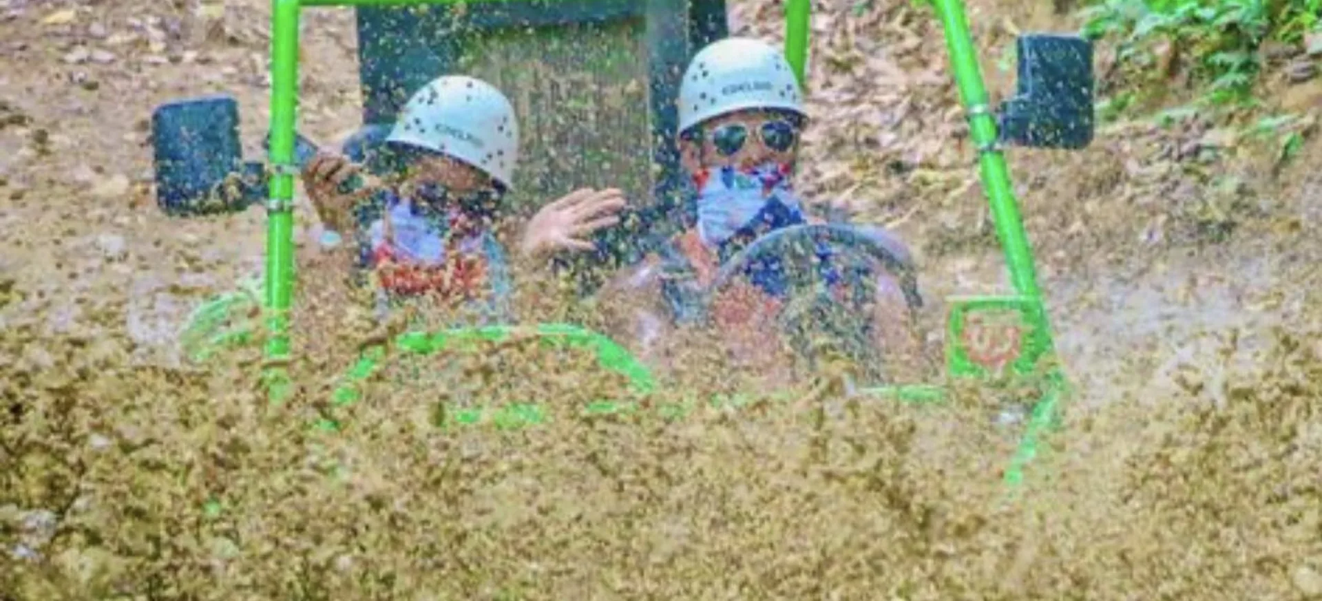 Guests splashing through mud in a buggy during an off-road excursion in Punta Cana
